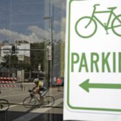 A reflection in a window of the Senior 3 division approaching the 3rd Avenue bridge during the 2009 Iowa Criterium Championship held in downtown Cedar Rapids on Sunday, July 5, 2009. (Chris Mackler/The Gazette)