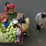 The Parekh family buys produce from a portable fruit and vegetable stand in Surat, Gujarat, India, on Jan. 7, 2008.