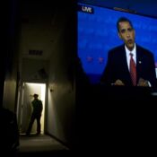 An Obama supporter stands in the doorway as the final Presidential debate is projected on the wall at the Campaign for Change student headquarters on Court Street in Athens, Ohio, October 15, 2008.
